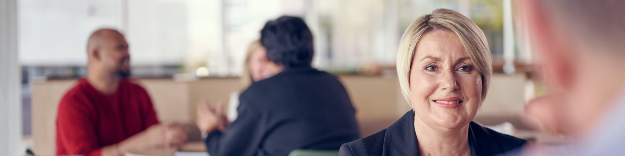 Woman sat talking to a colleague